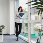 girl-posing-with-clipboard-office